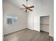 Bright bedroom with sleek flooring, ceiling fan, and a large window, offers comfort and style at 8632 Skyward Ct, Las Vegas, NV 89145