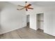Bright bedroom with sleek flooring, ceiling fan, and closet provides comfort and a clean aesthetic at 8632 Skyward Ct, Las Vegas, NV 89145