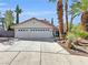 Charming single-story home featuring a two-car garage, mature landscaping, and a concrete driveway, perfect for suburban living at 8632 Skyward Ct, Las Vegas, NV 89145
