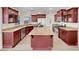 Modern kitchen featuring custom cabinetry, stainless steel appliances, a large island, and light countertops at 8632 Skyward Ct, Las Vegas, NV 89145