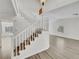 Bright staircase with white railings leads to an open-concept living space with modern flooring and natural light at 8632 Skyward Ct, Las Vegas, NV 89145