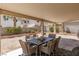 Covered back patio with a dining set perfect for outdoor entertaining at 9029 Tumblewood Ave, Las Vegas, NV 89143