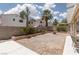 The backyard has a fire pit with easy landscaping and a block wall at 9029 Tumblewood Ave, Las Vegas, NV 89143