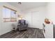Bright seating area in the bedroom features a recliner and window views at 9029 Tumblewood Ave, Las Vegas, NV 89143