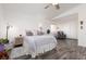 Spacious bedroom features a ceiling fan, wood-look floors, and a seating area by the window at 9029 Tumblewood Ave, Las Vegas, NV 89143