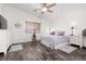 Comfortable bedroom with wood-look floors has a ceiling fan and plenty of natural light at 9029 Tumblewood Ave, Las Vegas, NV 89143