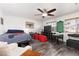 Spacious bedroom featuring wood floors, ceiling fan, natural light, and room for fun at 9029 Tumblewood Ave, Las Vegas, NV 89143