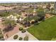 Aerial view of neighborhood green space, featuring trees, grass and walkways, surrounded by desert landscaping and homes at 9029 Tumblewood Ave, Las Vegas, NV 89143