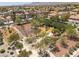 Aerial view of community playground with slide and benches, set amongst trees in a neighborhood with mountains in the distance at 9029 Tumblewood Ave, Las Vegas, NV 89143