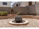 Backyard fire pit surrounded by brick trim and low-maintenance landscaping at 9029 Tumblewood Ave, Las Vegas, NV 89143