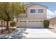 Inviting two-story home featuring a spacious three-car garage and well-maintained landscaping at 9029 Tumblewood Ave, Las Vegas, NV 89143
