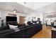 Bright living room features a vaulted ceiling, ceiling fan, and open floor plan to kitchen at 9029 Tumblewood Ave, Las Vegas, NV 89143