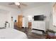 Spacious main bedroom with wood-look floors features a ceiling fan and access to the bathroom at 9029 Tumblewood Ave, Las Vegas, NV 89143