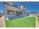 Landscaped backyard with artificial turf and a covered patio, designed for low maintenance and enjoyment at 9265 Frazer St, Las Vegas, NV 89166