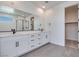 Modern bathroom boasts a double sink vanity, a large mirror, and a glass enclosed shower at 9265 Frazer St, Las Vegas, NV 89166