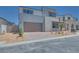 Beautiful two-story home showcasing a well-manicured front yard, a two-car garage, and modern architectural design at 9265 Frazer St, Las Vegas, NV 89166