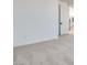 Landing area with white walls, carpet, and a door leading to another room at 9265 Frazer St, Las Vegas, NV 89166