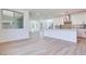 Bright living room with modern wood floors and updated kitchen with stainless steel appliances at 9265 Frazer St, Las Vegas, NV 89166