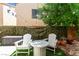 Backyard sitting area with a lush privacy screen and an outdoor table at 9613 Eland Ct, Las Vegas, NV 89149