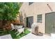 Cozy backyard area with patio furniture, artificial turf, and string lights create a relaxing outdoor space at 9613 Eland Ct, Las Vegas, NV 89149