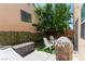 Landscaped backyard with a covered grill, seating, and a storage bench offers a great space for outdoor entertaining at 9613 Eland Ct, Las Vegas, NV 89149