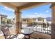 Balcony with outdoor seating overlooks neighborhood homes at 9613 Eland Ct, Las Vegas, NV 89149