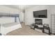 Bunk bed and TV in a carpetless bedroom illuminated by a chandelier at 9613 Eland Ct, Las Vegas, NV 89149