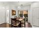 Dinning room with table, wooden chairs, view to the backyard, and white walls at 9613 Eland Ct, Las Vegas, NV 89149