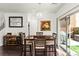 Comfortable dining area with backyard access, wooden table, and modern light fixture at 9613 Eland Ct, Las Vegas, NV 89149