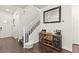 Inviting entryway featuring dark wood floors, staircase, and a decorative wine and coffee bar at 9613 Eland Ct, Las Vegas, NV 89149