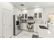Modern white kitchen featuring stainless steel appliances and quartz countertops at 9613 Eland Ct, Las Vegas, NV 89149