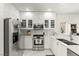 Modern kitchen with stainless steel appliances, white cabinets, and marble countertops at 9613 Eland Ct, Las Vegas, NV 89149