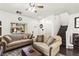 Comfortable living room with hardwood floors, neutral decor, and a staircase at 9613 Eland Ct, Las Vegas, NV 89149