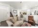 Open-concept living area with staircase, hardwood floors, and a view into the kitchen at 9613 Eland Ct, Las Vegas, NV 89149