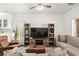 Cozy living room with comfortable seating, a ceiling fan, and a large entertainment center at 9613 Eland Ct, Las Vegas, NV 89149