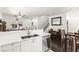 Bright living room with white cabinets and countertops and view into the dinning area at 9613 Eland Ct, Las Vegas, NV 89149
