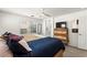 Bright main bedroom featuring a ceiling fan, large windows, and modern wooden furnishings at 9613 Eland Ct, Las Vegas, NV 89149