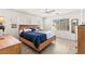 Comfortable main bedroom with a ceiling fan, a large window, and wooden furniture at 9613 Eland Ct, Las Vegas, NV 89149