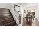 Hardwood staircase leading to the second floor, open to the dining area at 9613 Eland Ct, Las Vegas, NV 89149