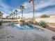 Backyard with swimming pool, waterfall feature, mature landscaping, and diving board at 9718 Camino Capistrano Ln, Las Vegas, NV 89147