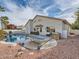 Gorgeous backyard featuring a swimming pool, mature landscaping, and a relaxing hammock at 9718 Camino Capistrano Ln, Las Vegas, NV 89147