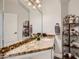 Charming bathroom with decorative shelving, granite countertops and a large mirror at 9718 Camino Capistrano Ln, Las Vegas, NV 89147