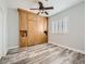 Functional bedroom with Murphy bed, ample built-in storage, window shutters, and luxury vinyl plank flooring at 9718 Camino Capistrano Ln, Las Vegas, NV 89147