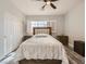 Comfortable bedroom featuring a large bed, luxury vinyl flooring, and a closet for storage at 9718 Camino Capistrano Ln, Las Vegas, NV 89147