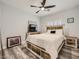 Cozy bedroom with a rustic wood bed frame and matching furniture and luxury vinyl flooring at 9718 Camino Capistrano Ln, Las Vegas, NV 89147