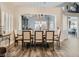 Elegant dining room with neutral tones, stylish lighting, and ample space for entertaining at 9718 Camino Capistrano Ln, Las Vegas, NV 89147