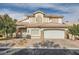 Beautiful two-story home with a well-maintained lawn and a two-car garage, showcasing its curb appeal at 9718 Camino Capistrano Ln, Las Vegas, NV 89147