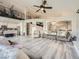 Bright and airy living space with soaring ceilings, modern staircase, and seamless flow to the kitchen at 9718 Camino Capistrano Ln, Las Vegas, NV 89147