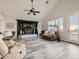 Bright living room featuring a fireplace, built-in shelves, and access to the outdoor patio at 9718 Camino Capistrano Ln, Las Vegas, NV 89147