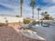 Outdoor oasis featuring pool, palm trees, mature plants, and lounge area, perfect for relaxation at 9718 Camino Capistrano Ln, Las Vegas, NV 89147